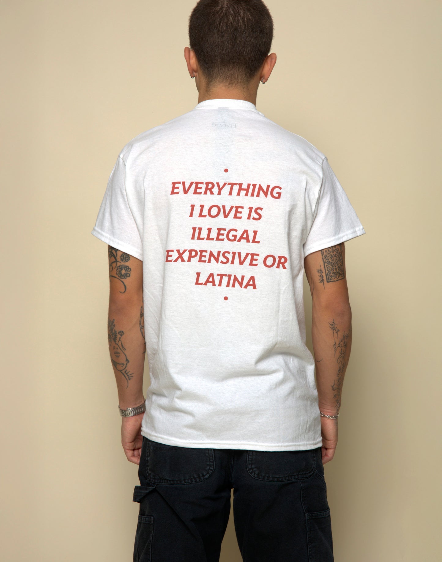 everything i love is illegal expensive or latina t-shirt white. By FRASED. Unisex heavy cotton tee with a crew neckline and graphic screen print, made from 100% cotton, featuring a classic fit and tear-away label for comfort.