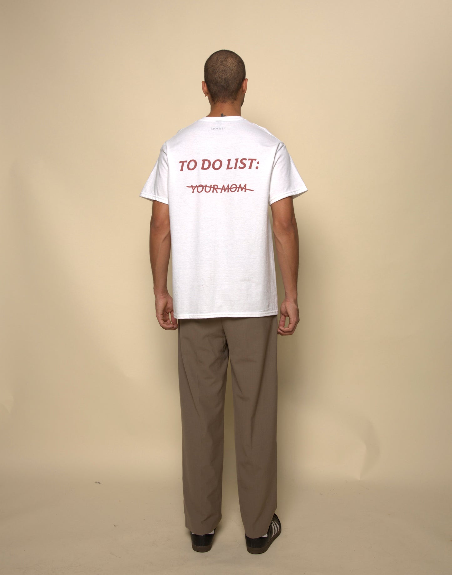 to do list: you mom t-shirt white. By FRASED. Unisex heavy cotton tee with a crew neckline and graphic screen print, made from 100% cotton, featuring a classic fit and tear-away label for comfort.