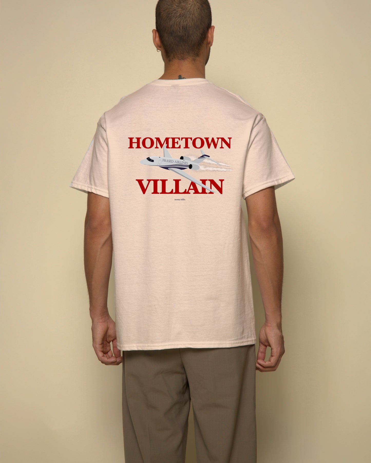 hometown villain t-shirt beige. By FRASED. Unisex heavy cotton tee with a crew neckline and graphic screen print, made from 100% cotton, featuring a classic fit and tear-away label for comfort.