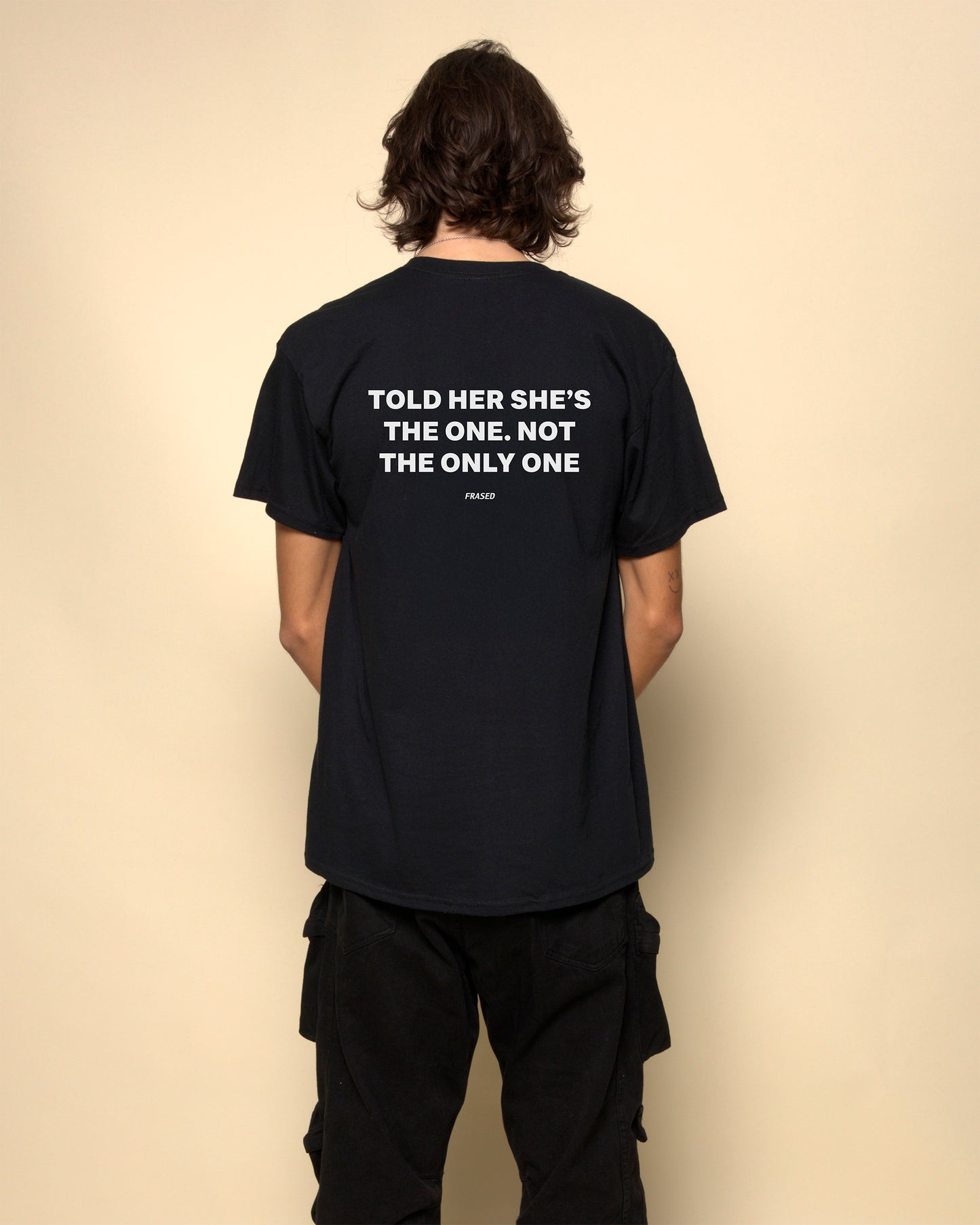 told her shes the one not the only one t-shirt black. By FRASED. Unisex heavy cotton tee with a crew neckline and graphic screen print, made from 100% cotton, featuring a classic fit and tear-away label for comfort.