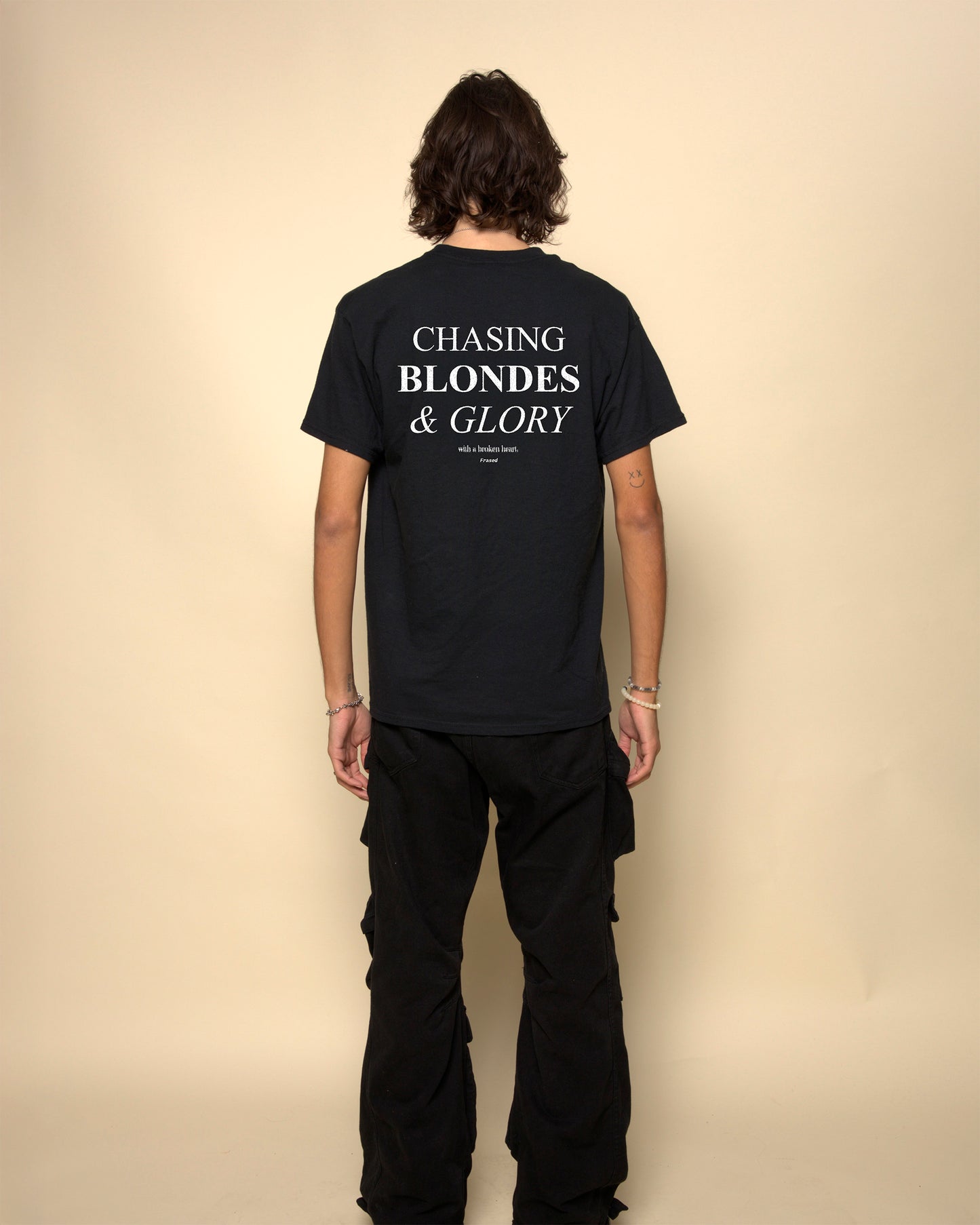 Chasing blondes and glory t-shirt black. By FRASED. Unisex heavy cotton tee with a crew neckline and graphic screen print, made from 100% cotton, featuring a classic fit and tear-away label for comfort.