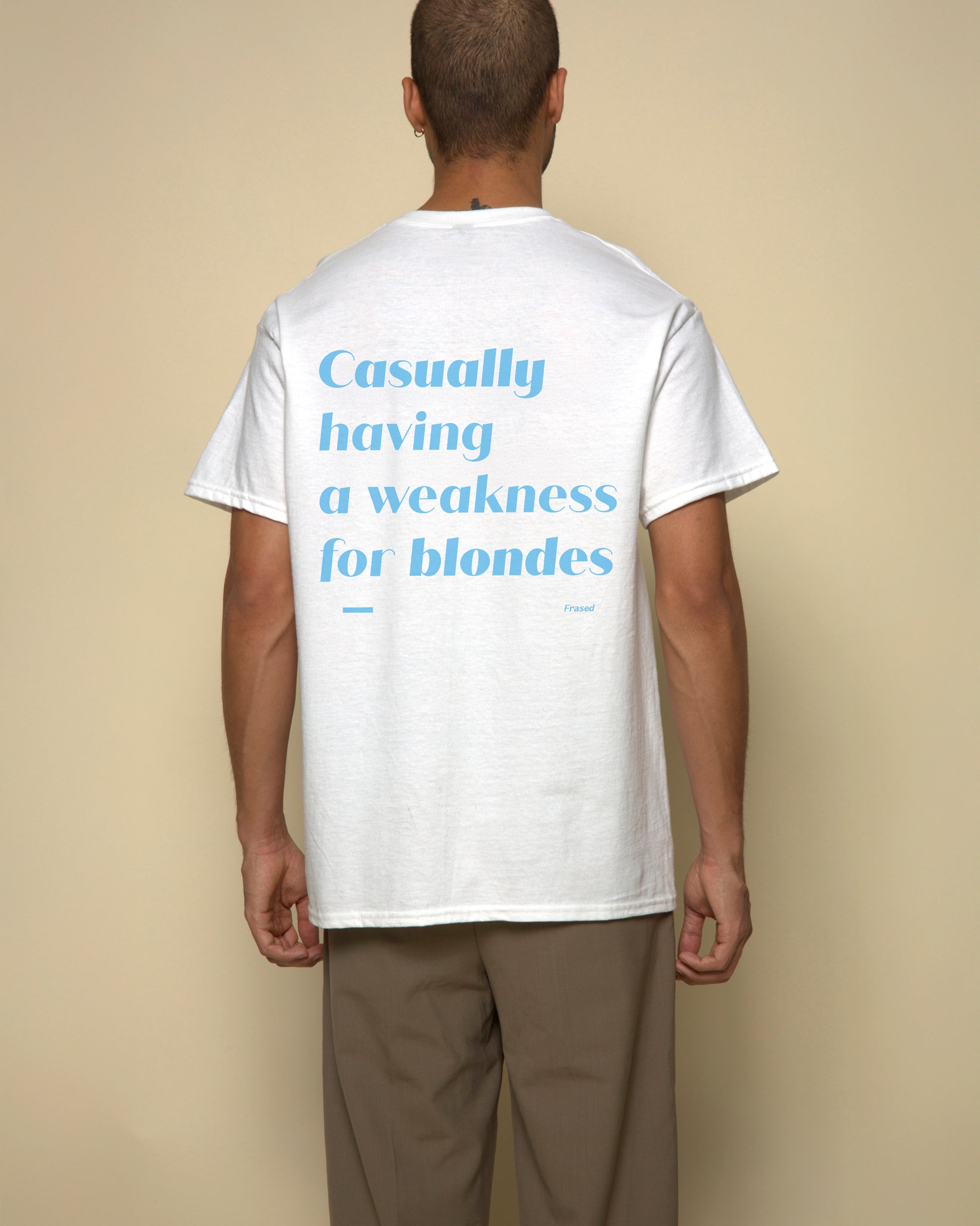 Casually having weakness for blondes t-shirt white. By FRASED. Unisex heavy cotton tee with a crew neckline and graphic screen print, made from 100% cotton, featuring a classic fit and tear-away label for comfort.