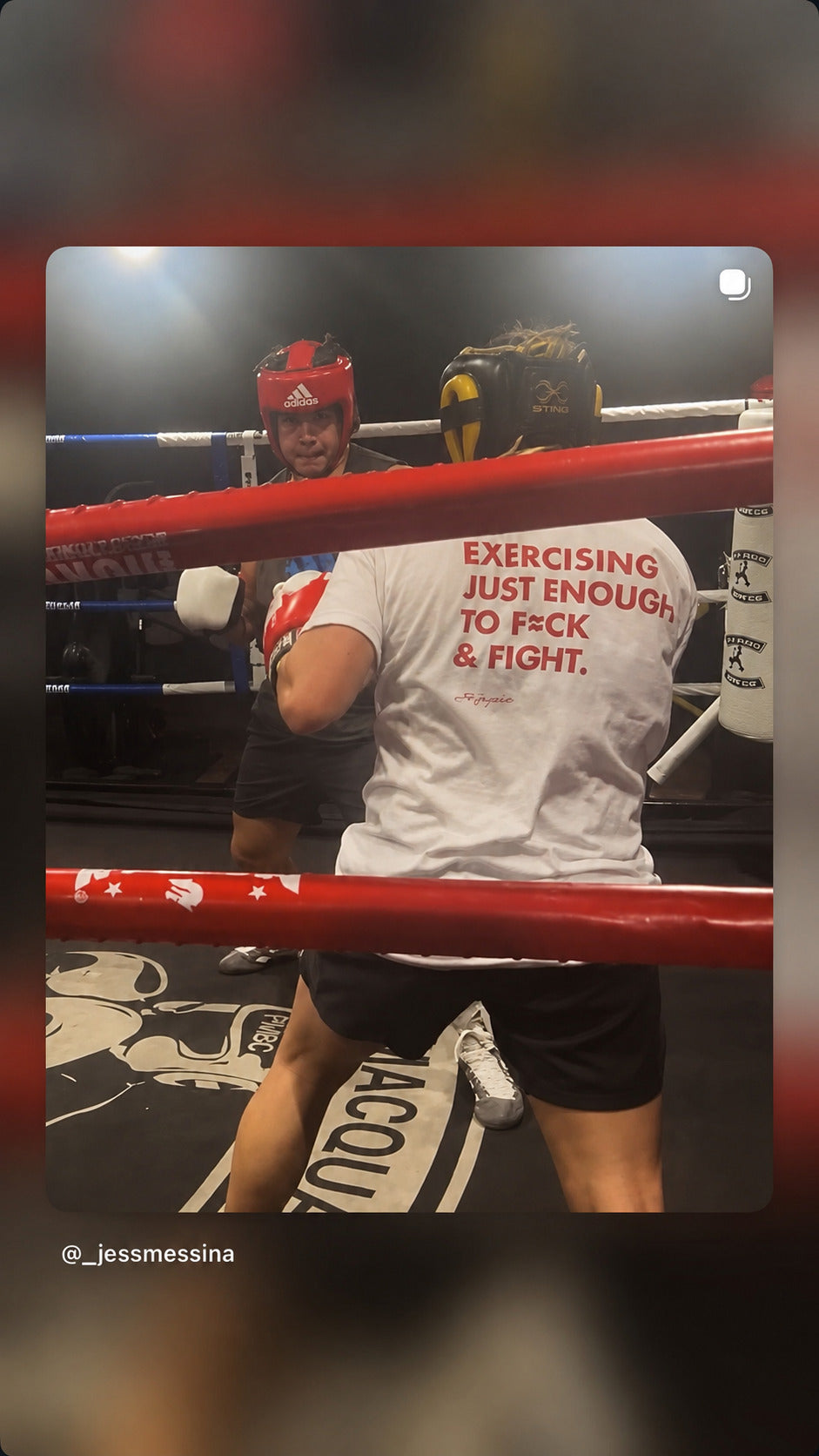 Boxer in a ring wearing a white “EXERCISING JUST ENOUGH TO F*CK & FIGHT” T-shirt.