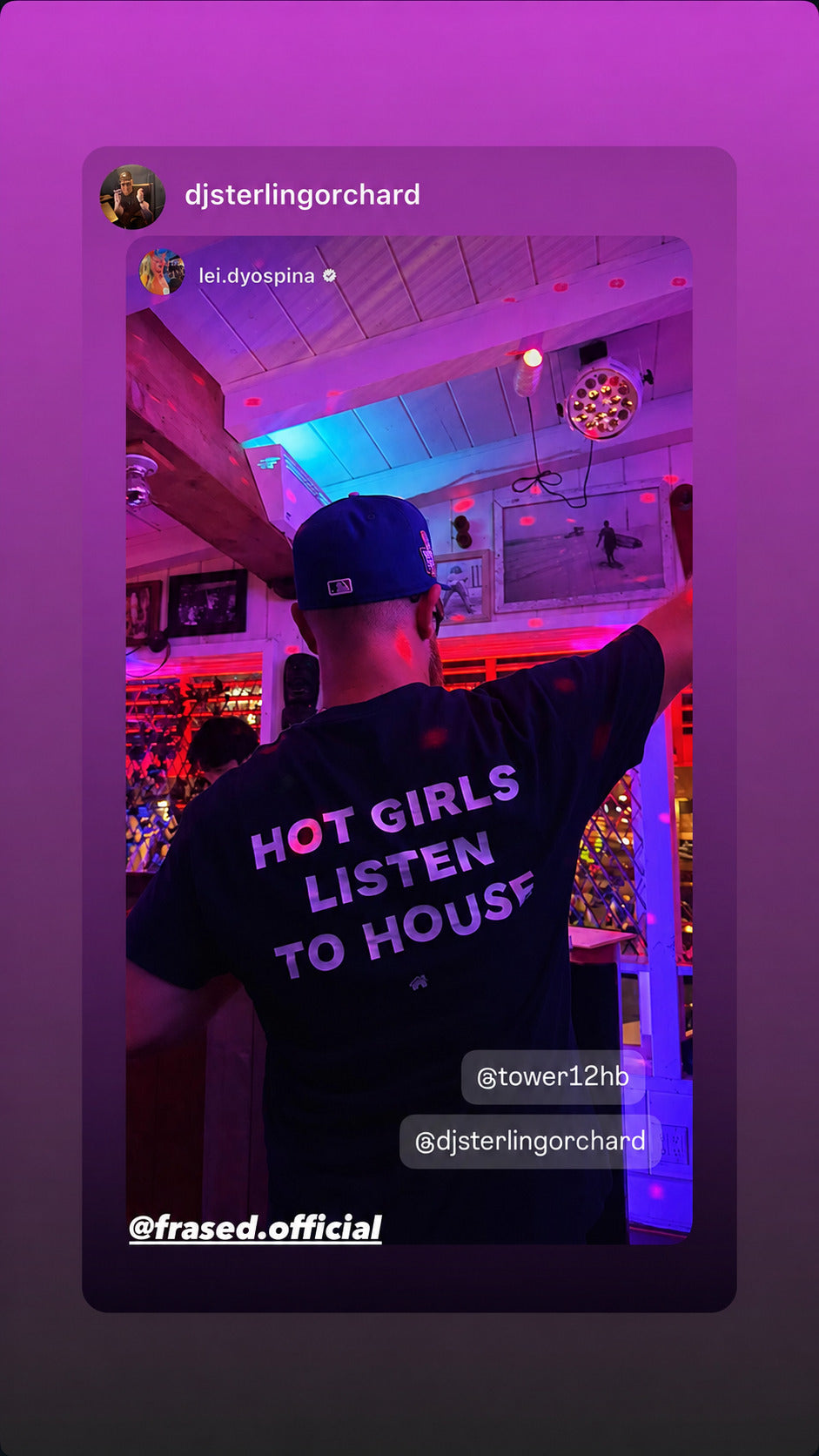 Man in a black “HOT GIRLS LISTEN TO HOUSE” T-shirt and cap under colorful club lights.
