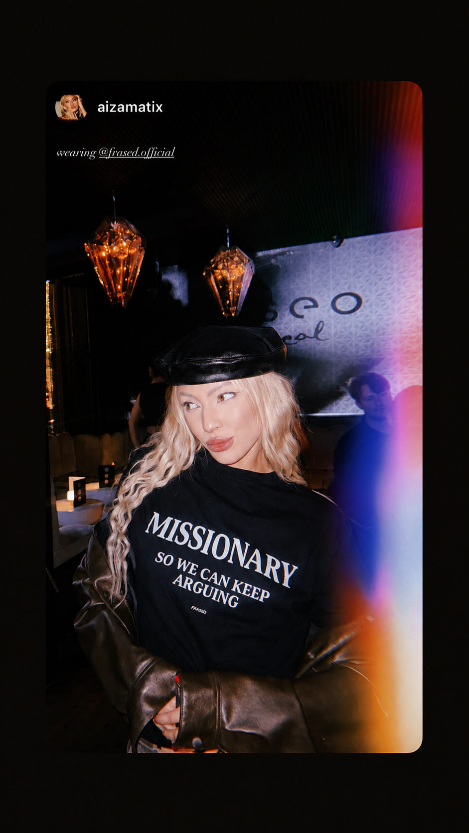 Woman in a cap wearing a black FRASED baby tee with “Missionary So We Can Keep Arguing” on the chest.