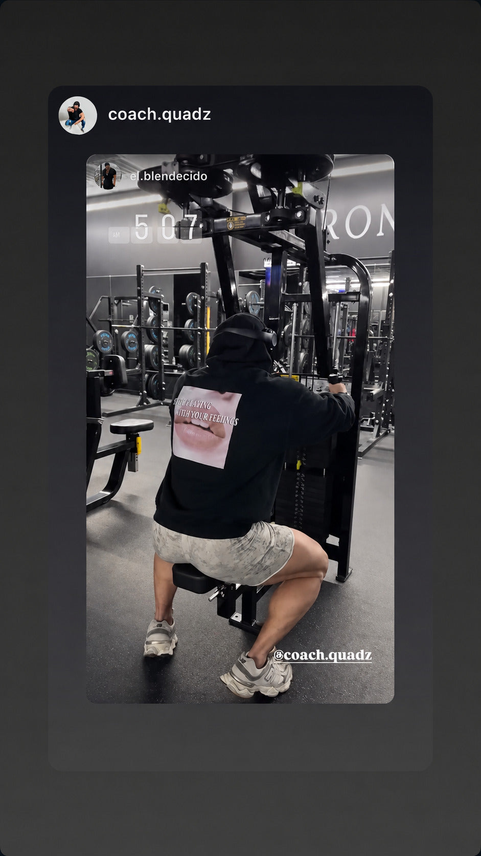 Person working out on a machine in a black “STILL PLAYING WITH YOUR FEELINGS” hoodie.