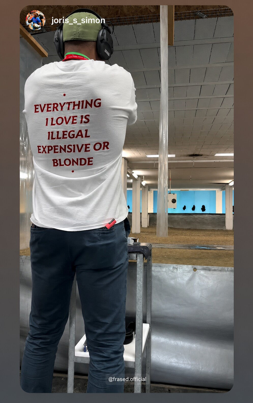 Person at a shooting range wearing a white “EVERYTHING I LOVE IS ILLEGAL EXPENSIVE OR BLONDE” T-shirt.